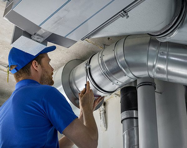 DunRite Heating & Air Inc. - hvac worker install ducted pipe