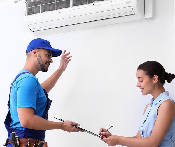 DunRite Heating & Air Inc. - Professional technician speaking with woman